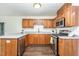 Bright kitchen with stainless steel appliances, laminate countertops and warm, wood cabinets at 112 Avent Pines Ln, Holly Springs, NC 27540