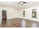 Spacious living room featuring hardwood floors and large windows that let in ample light at 112 Avent Pines Ln, Holly Springs, NC 27540