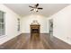 Bright living room featuring hardwood floors, a fireplace, and large windows at 112 Avent Pines Ln, Holly Springs, NC 27540
