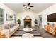 Comfortable living room with a neutral color palette, fireplace, and modern furnishings at 112 Avent Pines Ln, Holly Springs, NC 27540