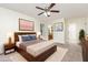 Staged main bedroom featuring a wooden bed frame, artwork, and adjacent bathroom at 112 Avent Pines Ln, Holly Springs, NC 27540