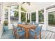 Cozy sunroom furnished with a dining table and comfortable seating, great for relaxing at 112 Avent Pines Ln, Holly Springs, NC 27540