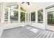 Bright sunroom with vaulted ceilings, ample windows, and a ceiling fan at 112 Avent Pines Ln, Holly Springs, NC 27540