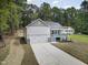 Aerial view showcases a delightful home with front-facing garage and porch at 113 Pueblo Dr, Louisburg, NC 27549