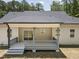 Spacious covered porch featuring a ceiling fan and sliding glass doors, seamlessly connecting indoor and outdoor living spaces at 113 Pueblo Dr, Louisburg, NC 27549