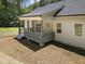 Inviting covered porch with grey railings and steps, enhancing the home's appeal with easy access to the expansive backyard at 113 Pueblo Dr, Louisburg, NC 27549