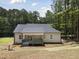 Enjoy outdoor living with this covered porch, perfect for relaxing and entertaining with views of the wooded backyard at 113 Pueblo Dr, Louisburg, NC 27549