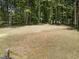 Grassy backyard offering plenty of space for outdoor activities, gardening, and enjoying the surrounding natural beauty at 113 Pueblo Dr, Louisburg, NC 27549