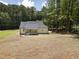 Large backyard surrounded by mature trees, offering privacy and space for outdoor activities and landscaping opportunities at 113 Pueblo Dr, Louisburg, NC 27549