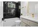 Modern bathroom featuring black marble wall tile, gold fixtures, and white vanity at 113 Pueblo Dr, Louisburg, NC 27549