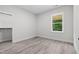 Bright bedroom features wood-look flooring, walk-in closet, and a window with a view at 113 Pueblo Dr, Louisburg, NC 27549