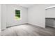 This spacious bedroom features wood-look flooring and a sun-filled window with views at 113 Pueblo Dr, Louisburg, NC 27549