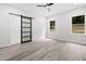Spacious bedroom features modern ceiling fan, backyard view, and decorative sliding barn door at 113 Pueblo Dr, Louisburg, NC 27549