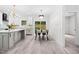 Open-concept kitchen and dining area with modern light fixtures and backyard access at 113 Pueblo Dr, Louisburg, NC 27549
