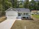 Charming new home with a covered porch, 2-car garage and a beautiful landscaped front yard at 113 Pueblo Dr, Louisburg, NC 27549