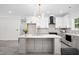 Modern kitchen with an island, sleek countertops, stainless steel appliances and updated cabinetry at 113 Pueblo Dr, Louisburg, NC 27549