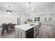 This open-concept kitchen features an island, modern appliances, and seamless flow into the dining and living areas at 113 Pueblo Dr, Louisburg, NC 27549