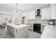 Modern kitchen with a large island, sleek countertops, stainless steel appliances and a statement gold faucet at 113 Pueblo Dr, Louisburg, NC 27549