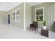 Relaxing porch features comfortable seating and tranquil views of lush landscaping at 113 Pueblo Dr, Louisburg, NC 27549