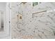 Walk-in shower featuring marble tiling, rainfall shower head, and a built-in shower bench at 113 Pueblo Dr, Louisburg, NC 27549