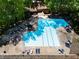 Aerial view of community pool with lounge chairs and pristine blue water at 113 Twisted Oak Pl, Durham, NC 27705