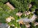 A serene aerial view of a community with trees, tennis courts, parking, and a playground at 113 Twisted Oak Pl, Durham, NC 27705