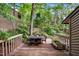 Large back deck with a dining table surrounded by greenery at 113 Twisted Oak Pl, Durham, NC 27705