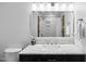 Elegant bathroom featuring a sleek vanity, marble countertop, illuminated mirror, and modern fixtures at 113 Twisted Oak Pl, Durham, NC 27705