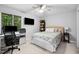 A comfortable bedroom with desk area, ceiling fan, a large window, and a cozy bed at 113 Twisted Oak Pl, Durham, NC 27705