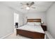 A cozy bedroom with hardwood furniture, neutral walls, ceiling fan, and ensuite bathroom at 113 Twisted Oak Pl, Durham, NC 27705