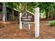 Community clubhouse sign with address and manicured landscaping at 113 Twisted Oak Pl, Durham, NC 27705