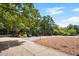 Well-maintained community entrance featuring lush landscaping, street signage, and convenient parking at 113 Twisted Oak Pl, Durham, NC 27705