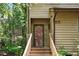 Close-up of the front entrance with wood door and staircase to the home at 113 Twisted Oak Pl, Durham, NC 27705