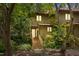 Charming townhouse with wood siding, lush landscaping, and inviting wooden staircase at 113 Twisted Oak Pl, Durham, NC 27705