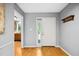 Bright foyer with light-colored walls, wood floors, and coat rack at 113 Twisted Oak Pl, Durham, NC 27705