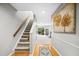 Entryway with stairs leading upstairs and a view into the living room at 113 Twisted Oak Pl, Durham, NC 27705