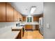 Well-lit kitchen with stainless steel appliances and wood cabinets at 113 Twisted Oak Pl, Durham, NC 27705