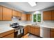 Well-lit kitchen features wood cabinets and stainless steel appliances at 113 Twisted Oak Pl, Durham, NC 27705