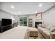 Bright living room with sliding glass doors to the backyard deck at 113 Twisted Oak Pl, Durham, NC 27705