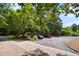 This parking lot is a spacious area with a variety of cars, surrounded by lush green trees at 113 Twisted Oak Pl, Durham, NC 27705
