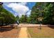 Community playground with slides, swings, and picnic tables under a canopy of mature trees at 113 Twisted Oak Pl, Durham, NC 27705