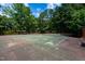 Well-maintained tennis court with surrounding greenery and plenty of room for play at 113 Twisted Oak Pl, Durham, NC 27705