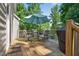Spacious back deck with a table, chairs, umbrella, and grill, perfect for outdoor dining at 1205 Magnolia Hill Rd, Garner, NC 27529