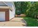 Home exterior view showing a brick and vinyl siding, with a driveway at 1205 Magnolia Hill Rd, Garner, NC 27529