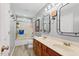 Bathroom featuring dual sinks, a tub shower, and modern fixtures at 1205 Magnolia Hill Rd, Garner, NC 27529
