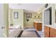 Well-lit bathroom showcasing a tub, a single vanity, and neutral tones at 1205 Magnolia Hill Rd, Garner, NC 27529