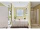 Bathroom with a tub, transom window, and a separate glass shower at 1205 Magnolia Hill Rd, Garner, NC 27529