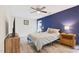 Bedroom showcasing a bright blue accent wall and modern furnishings at 1205 Magnolia Hill Rd, Garner, NC 27529