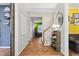Welcoming entryway with herringbone wood floors, staircase, and stylish decor throughout at 1205 Magnolia Hill Rd, Garner, NC 27529