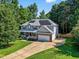 Two-story home with solar panels, a front porch, and a well-manicured lawn at 1205 Magnolia Hill Rd, Garner, NC 27529